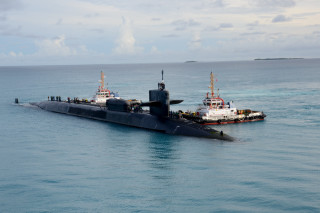Submarine tugboat ocean cloudy sky - small free wallpaper