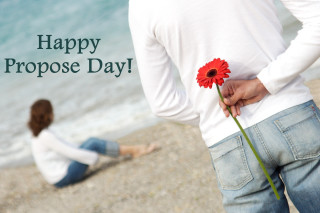Man holding flower woman beach - day free wallpaper