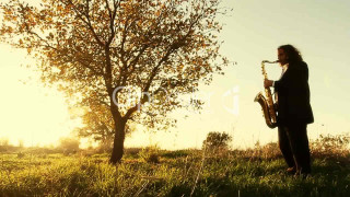 Man playing saxophone field sunset - sunset free wallpaper