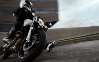 Man motorcycle street tall building - a tall building free wallpaper