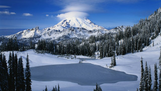 Snow covered mountain lake trees - a lake in the foreground and trees free wallpaper