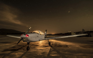 Small airplane night tarmac city - atmospheric free wallpaper
