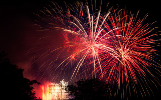 Fireworks tower trees precisionism redsky - free new year wallpaper