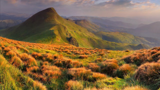 Grassy mountain cloudy sky autumn - a grassy field free wallpaper