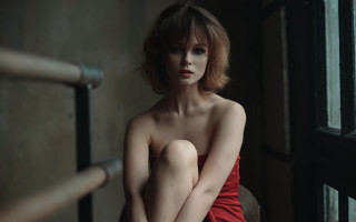 Red dress woman portrait indoor - a chair in a room free wallpaper