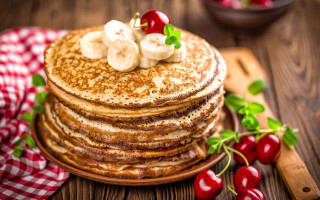 Pancakes bananas cherries wooden table - a stack of pancakes free wallpaper