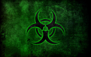 Green biohazard symbol dark background - a grungy effect free wallpaper