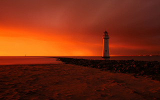 Lighthouse rocky shore sunset red 2 - a red sky in the background free wallpaper