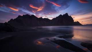 Sunset mountain range water clouds - a sunset over a mountain range free wallpaper