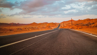 Mountain road sunset ocean clouds - a sky background and a mountain range in the distance free wallpaper