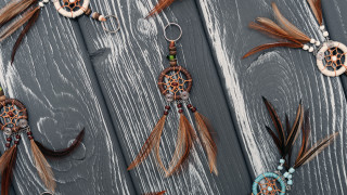 Feathers beads wooden surface keychain - high detail 8 k free wallpaper