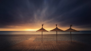 Umbrellas pier ocean sunset cloudy - ferenc joachim free wallpaper