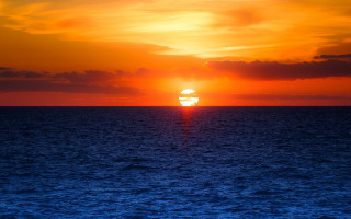 Sunset ocean boat orange sky - a sunset over the ocean free wallpaper