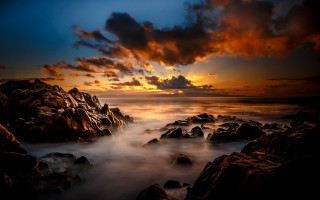 Sunset rocky beach clouds ocean - a sunset over a rocky beach free wallpaper