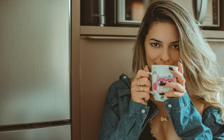 Surprised woman holding cup portrait - a cup free wallpaper