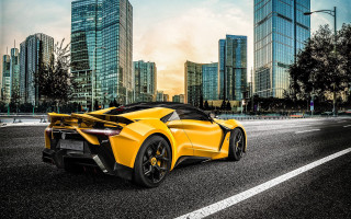 Yellow sports car cityscape night - side profile free wallpaper