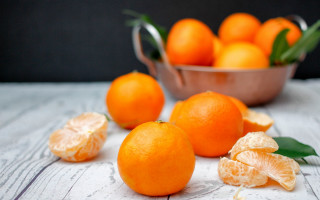 Bowl oranges tangerines leaves still - a table top free wallpaper