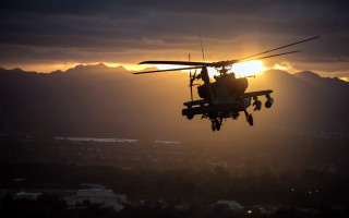 Helicopter sunset mountains clouds lensflare - the sun setting behind free wallpaper