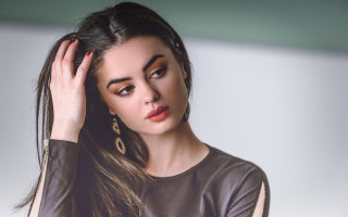 Woman longhair brownshirt handonhead lookingatcamera - a brown shirt free wallpaper