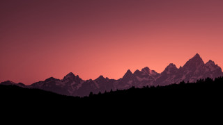Mountain range sunset trees silhouette - a red sky in the background free wallpaper