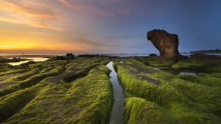 Mossy rock sunset cloudy sky - a large rock free wallpaper