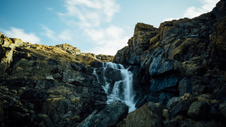 Waterfall cliff blue sky clouds - a rocky cliff free wallpaper