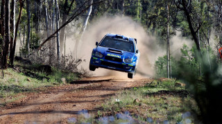 Blue car jumping dirt road - a blue car free wallpaper