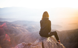 Woman sitting valley mountains sunset - sunrise free wallpaper for desktop