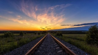 Train track sunset clouds grass - liminal free wallpaper for desktop