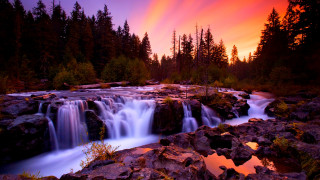 Waterfall sunset trees foreground nature - a red sky in the background free wallpaper