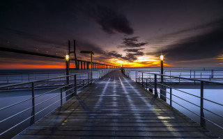 Sunset pier cityscape mountain ocean - a few light free wallpaper