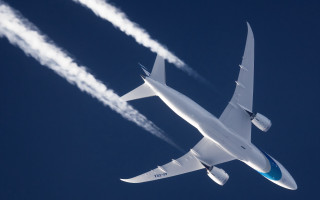 Large jetliner blue sky smoke 2 - free airplane wallpaper