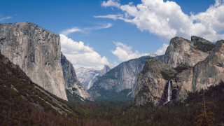 Mountain waterfall cloudy sky landscape - a waterfall in the middle of it free wallpaper