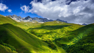 Green valley mountains clouds trees - a green valley free wallpaper