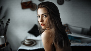 Woman long hair bedroom portrait - a bed and a wall free wallpaper