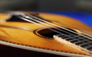 Guitar closeup blurry strings frets - a close up of a guitar free wallpaper