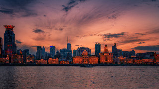 Sunset cityscape boat river mountain - the water near a city free wallpaper
