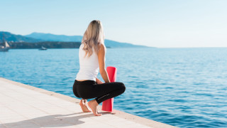 Woman sitting red pole water - full body pose free wallpaper