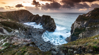 Rocky cliff water cloudy sky 3 - a rocky cliff free wallpaper