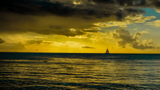 Sailboat ocean sunset cloudy sky 5 - a sailboat free wallpaper