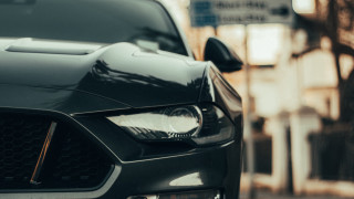 Car front bumper headlights city - a building in the background free wallpaper