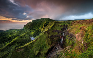 Lush green waterfall hillside cloudy - a waterfall below free wallpaper