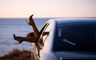 Woman leaning out car window 2 - a car window free wallpaper