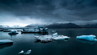 Icebergs water mountains clouds bird - the water under a cloudy sky free wallpaper