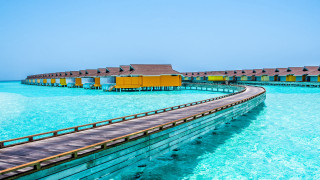 Wooden walkway houses water beach - a wooden walkway free wallpaper