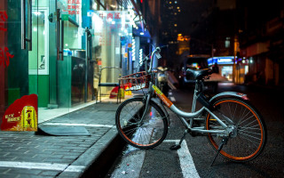 Bicycle street night neon building - a bicycle free wallpaper