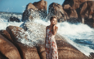 Woman rock ocean phone splashing - a phone free wallpaper