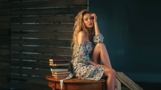 Woman sitting books floral dress - front of her free wallpaper