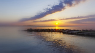 Sunset water dock clouds impressionist - a dock in the foreground free wallpaper