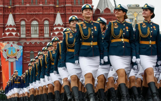 Marching women uniform parade clocktower - a clock tower in the background free wallpaper